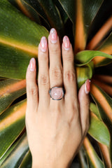 Rose Quartz Floral Silver Ring shown worn on hand with oxidized sterling silver and pale pink Rose Quartz centre.