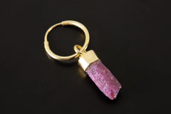 Ruby single hoop earring shown on dark background with gold-plated sterling silver and vivid pink-red crystal.