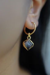 Rubellite Pink Tourmaline gold-plated sterling silver hoop earring worn on a model as a single dangle charm.