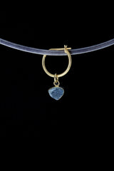 Blue Tourmaline gold-plated hoop earring shown on dark background with raw blue gemstone slice.