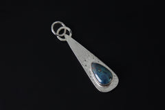 Chrysocolla sterling silver pendant shown on a necklace with hammered silver texture and blue-green teardrop gemstone.