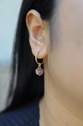 Watermelon Tourmaline gold-plated sterling silver hoop earring worn on a model as a single dangle charm.