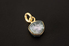 Close-up of Blue Tourmaline slice charm showing raw gemstone texture and gold-plated silver bail.