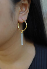 Australian Aquamarine hoop earrings shown worn on the ear, with gold-plated sterling silver hoops and soft blue crystals.
