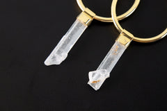 Close-up of Australian Aquamarine convertible earrings showing pale blue crystals and warm gold-plated silver hoops.