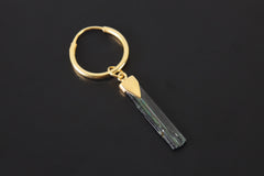 Golden Green Tourmaline Heart earring pendant shown on dark background with warm gold hoop and Verdelite charm.