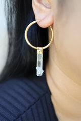 Australian Aquamarine hoop earrings shown worn on the ear, with gold-plated sterling silver hoops and clear blue crystals.