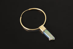 Angel Aura Quartz dangle hoop earring shown on dark background with gold-plated sterling silver and rainbow crystal point.