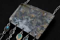 Close-up of large rectangular Inclusion Quartz centrepiece with internal rainbows, sterling silver setting, and gemstone dangles.