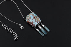 Larimar Aquamarine pendant on a sterling silver chain, shown on a dark background with a raw blue Larimar centrepiece and three Aquamarine dangles.