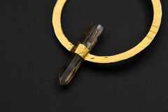 Close-up of Smoky Quartz portal earring showing silver circle setting, gold hook, and smoky crystal point.