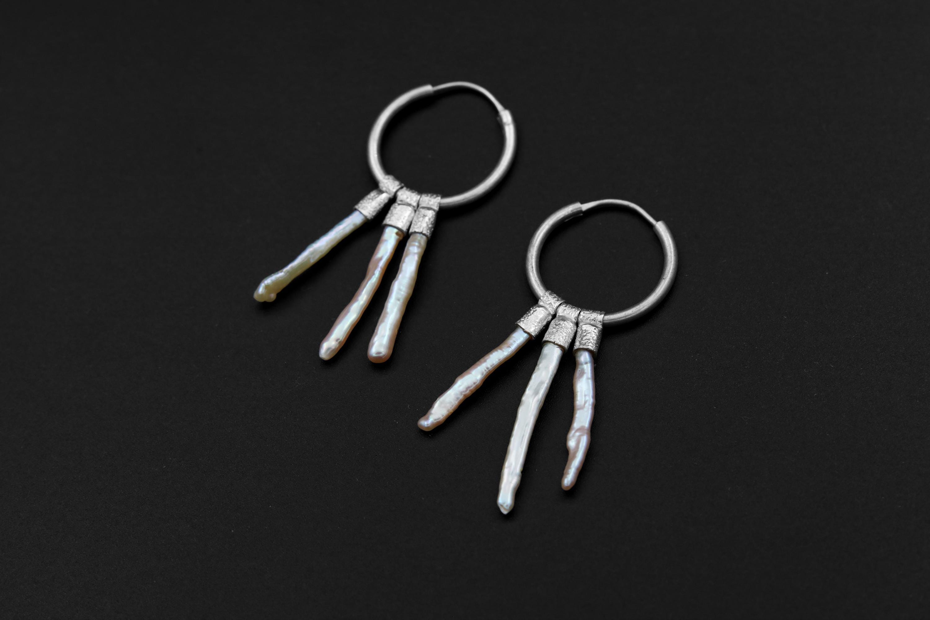 Moonlit Pearl stack hoop earrings shown on dark background with large sterling silver hoops and three Pearl dangles.