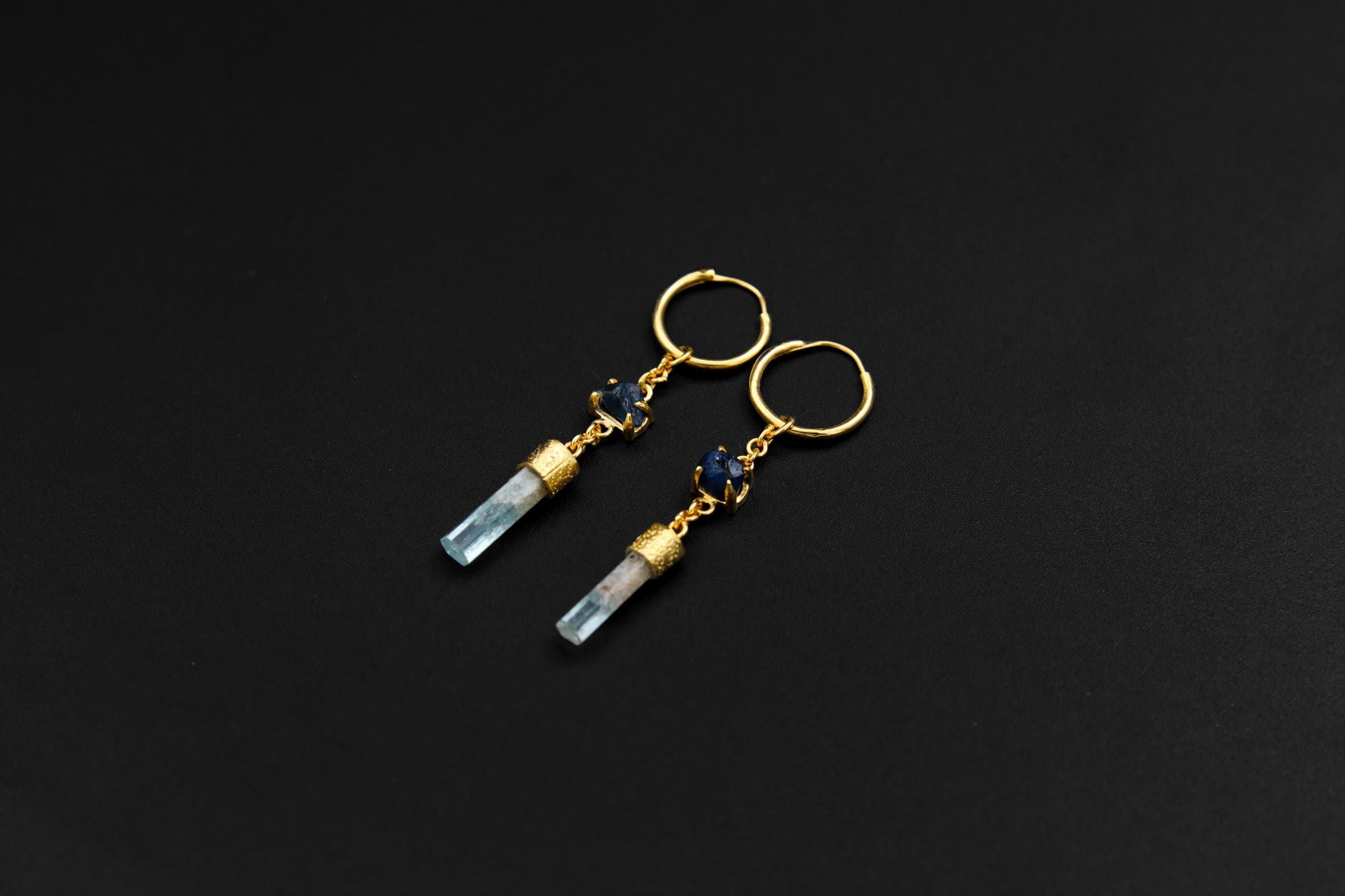 Sapphire and Aquamarine gold-plated hoop earrings shown on dark background with petite 18k gold sterling silver hoops.