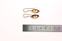 White Lightning Ridge Opal earrings shown beside a ruler for scale, with gold-plated hooks and small halo dangles.