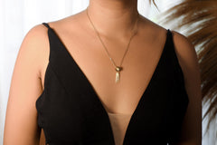 Blue Moonstone stack pendant shown worn on a necklace, with compact gold-plated charm shape and long moving dangles.