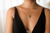 Faceted Red Kyanite slice pendant in 18k gold-plated sterling silver, shown worn on a necklace with compact geometric shape.