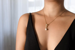 Compact Moonstone Opal Shell pendant shown worn on a necklace, with 18k gold-plated sterling silver setting.