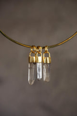 Small Australian Quartz point pendant shown on a gold-toned necklace, with clear crystal wand shape and gold-plated cap.