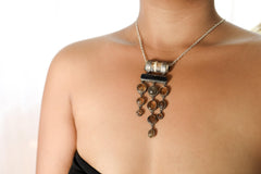 Carved Bone Black Tourmaline Mexican Amber Labradorite pendant shown worn on the chest with handmade sterling silver setting.