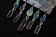 Close-up of Labradorite, Tourmaline, Ethiopian Opal, and Pink Tourmaline dangles beneath a sterling silver Inclusion Quartz necklace.
