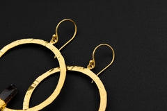 Smoky Quartz portal earrings shown with gold-plated hooks, silver texture, and earthy brown crystal points.