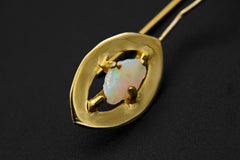 Single White Lightning Ridge Opal earring shown close-up with warm gold-plated halo frame and organic Opal chip.