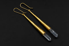 Gold-plated Chlorite Phantom Quartz earrings shown on a dark background with slender long dangle construction.