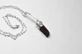 Blue Apatite Ethiopian Opal pendant shown with sterling silver chain, featuring a blue generator point and small opal accent.
