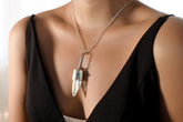 Lemurian Angel Aura Quartz Apatite pendant shown worn on a model, with sterling silver setting and long iridescent crystal point.