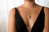 Spinning Vera Cruz Amethyst and Opal Pendant shown worn on the chest with high-polish sterling silver and gold-toned cord.