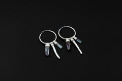 Celestial Gatherer crystal stack hoop earrings shown on dark background with sterling silver hoops and mixed gemstone dangles.
