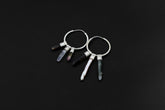 Celestial Gatherer crystal stack hoop earrings shown on dark background with sterling silver hoops and mixed gemstone dangles.