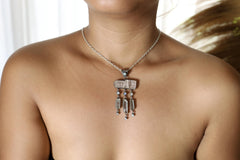 Lightning Ridge Opal Kunzite Moonstone Aquamarine pendant shown worn on the chest with soft celestial gemstone flow.
