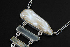 Close-up of Raw Pearl and Himalayan Aquamarine wands in a hammer-textured sterling silver aquatic pendant.
