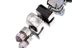 Close-up of Black Tourmaline, Selenite, and Amethyst details in a layered oxidized sterling silver talisman pendant.
