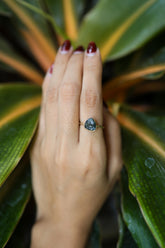 Gold-plated 925 sterling silver Blue Tourmaline ring shown worn on the hand, with teal Indicolite stone and slim band.
