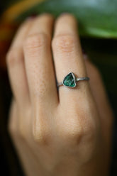 Handmade 925 sterling silver Emerald ring shown worn on the hand, with a vivid green beryl gemstone and solid silver band.