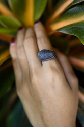 Raw Tanzanite Silver Ring shown worn on hand with blue-violet gemstone and hand-hammered sterling silver band.