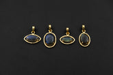 Madagascan Labradorite claw pendants in 18k gold-plated sterling silver, shown together with blue-green gemstone flash.