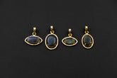 Madagascan Labradorite claw pendants in 18k gold-plated sterling silver, shown together with blue-green gemstone flash.