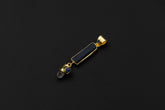 Blue Moonstone, Tourmaline, Smoky Quartz, and Blue Sapphire pendant in 18k gold-plated sterling silver on a dark background.