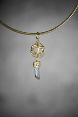 Gold-plated Lemurian Quartz and Blue Moonstone pendant shown on a necklace, with geometric cage design and vertical crystal drop.
