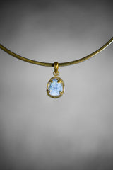 Lightning Ridge Opal Doublet pendant shown worn on a necklace, with compact hammered gold-plated oval frame.