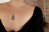 Winton Boulder Opal pendant shown worn on a model, with textured sterling silver bezel and long freeform Queensland opal.