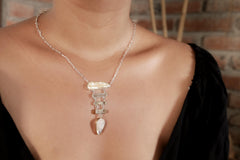 Raw Pearl Aquamarine Blue Moonstone necklace shown worn on the chest, with open-back silver settings and cascading gemstone dangles.