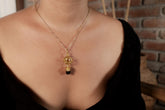 Himalayan Brown Tourmaline Ethiopian Opal sphere pendant shown worn on a necklace, with 18k gold-plated sterling silver.