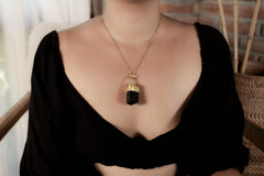 Himalayan Dravite Tourmaline Diamond pendant shown worn on a model, with gold-plated sand-textured setting.