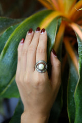 Pearl textured loop ring shown worn on the hand, with adjustable sterling silver band and luminous white Pearl.