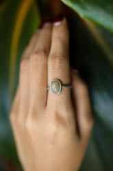 Handmade 925 sterling silver Ethiopian Opal ring shown worn on the hand, with soft luminous opal and sturdy silver band.