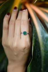Handmade 925 sterling silver Emerald ring shown worn on the hand, with a vivid green beryl gemstone and solid silver band.